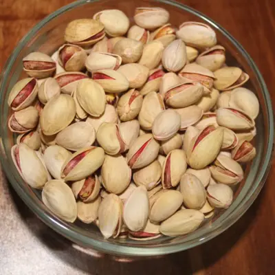 Premium Iran pistachios served in a glass bowl — AM Nuts & Spices